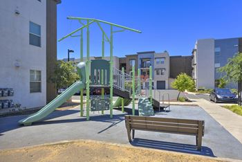 Childrens playground with green climbing structure